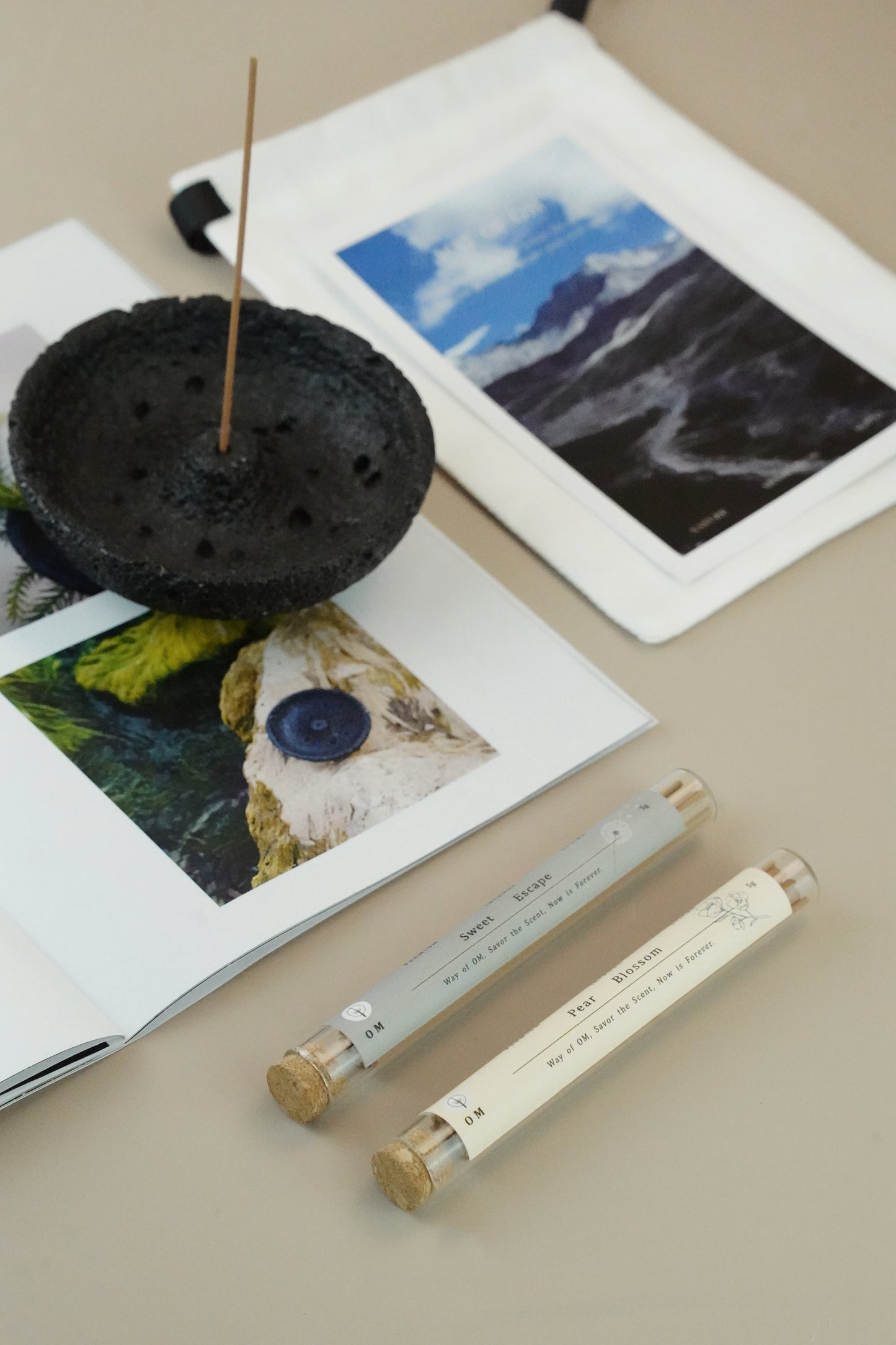 Pear Blossom and Sweet Escape incense sticks with black plaster holder on white table – OM natural scent set