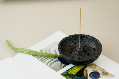 Close-up of black volcanic plaster incense holder with two incense sticks – OM scent pairing set