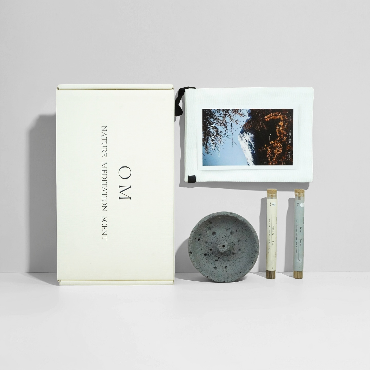 Floating Sea and Sweet Escape incense set with grey volcanic holder, cotton pouch and ritual card – OM gift box presentation