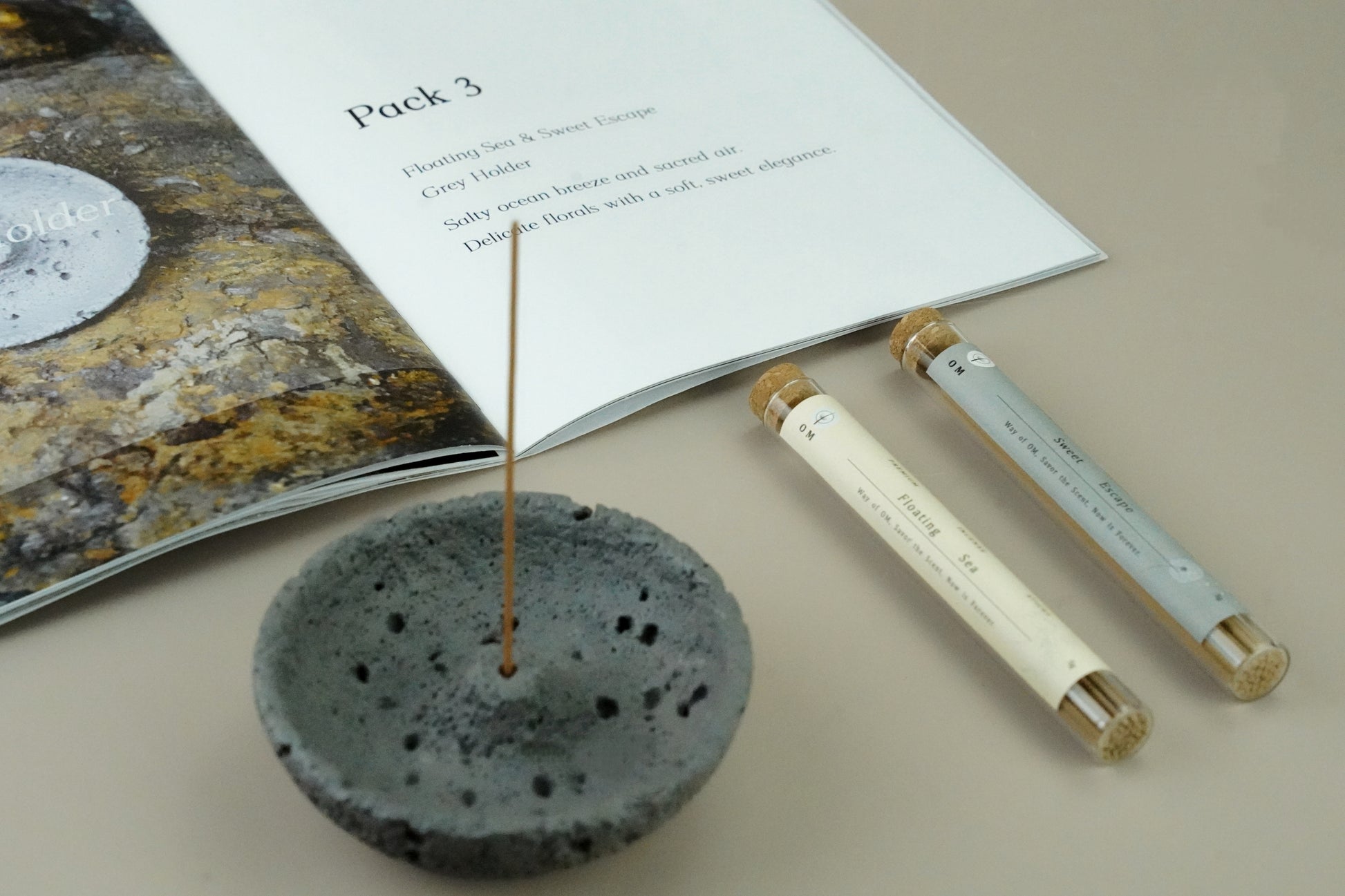 OM incense set with grey incense holder and fragrance card, flat lay with Floating Sea and Sweet Escape sticks