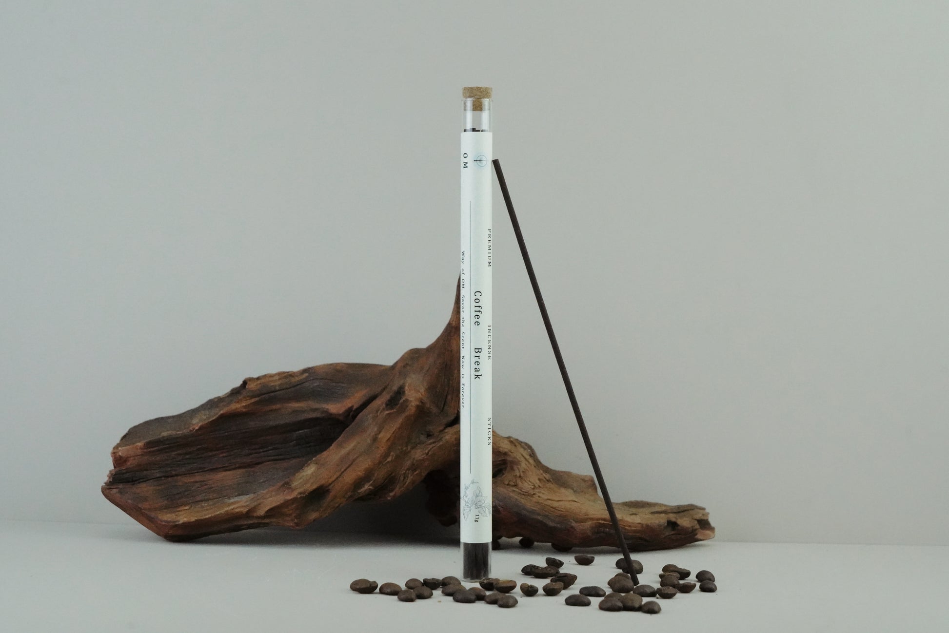 OM incense tube with coffee-themed design on wooden surface and natural linen – rustic warmth
