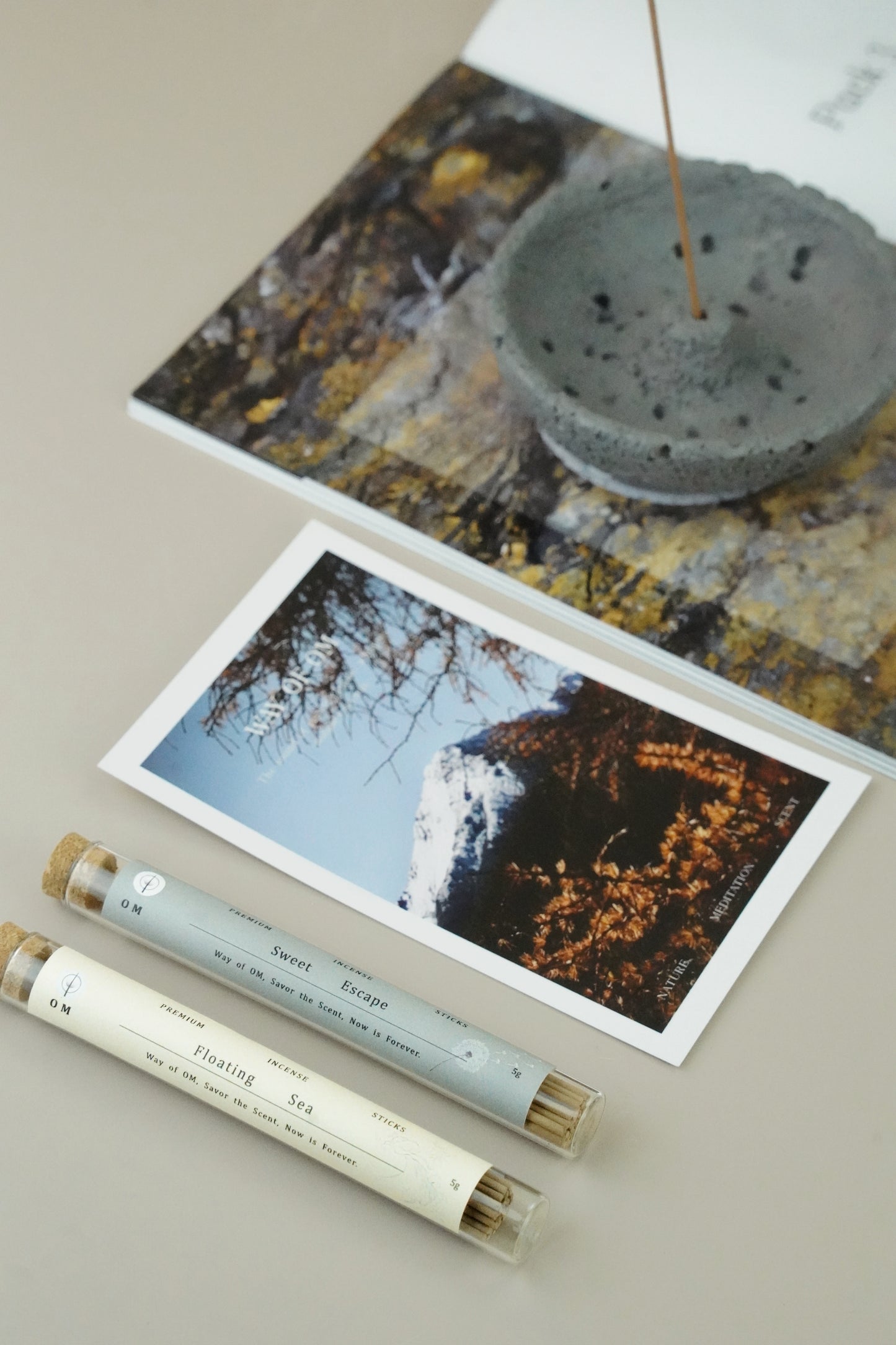 Open gift box with incense sticks and grey plaster holder on wooden surface – Way of OM natural incense set